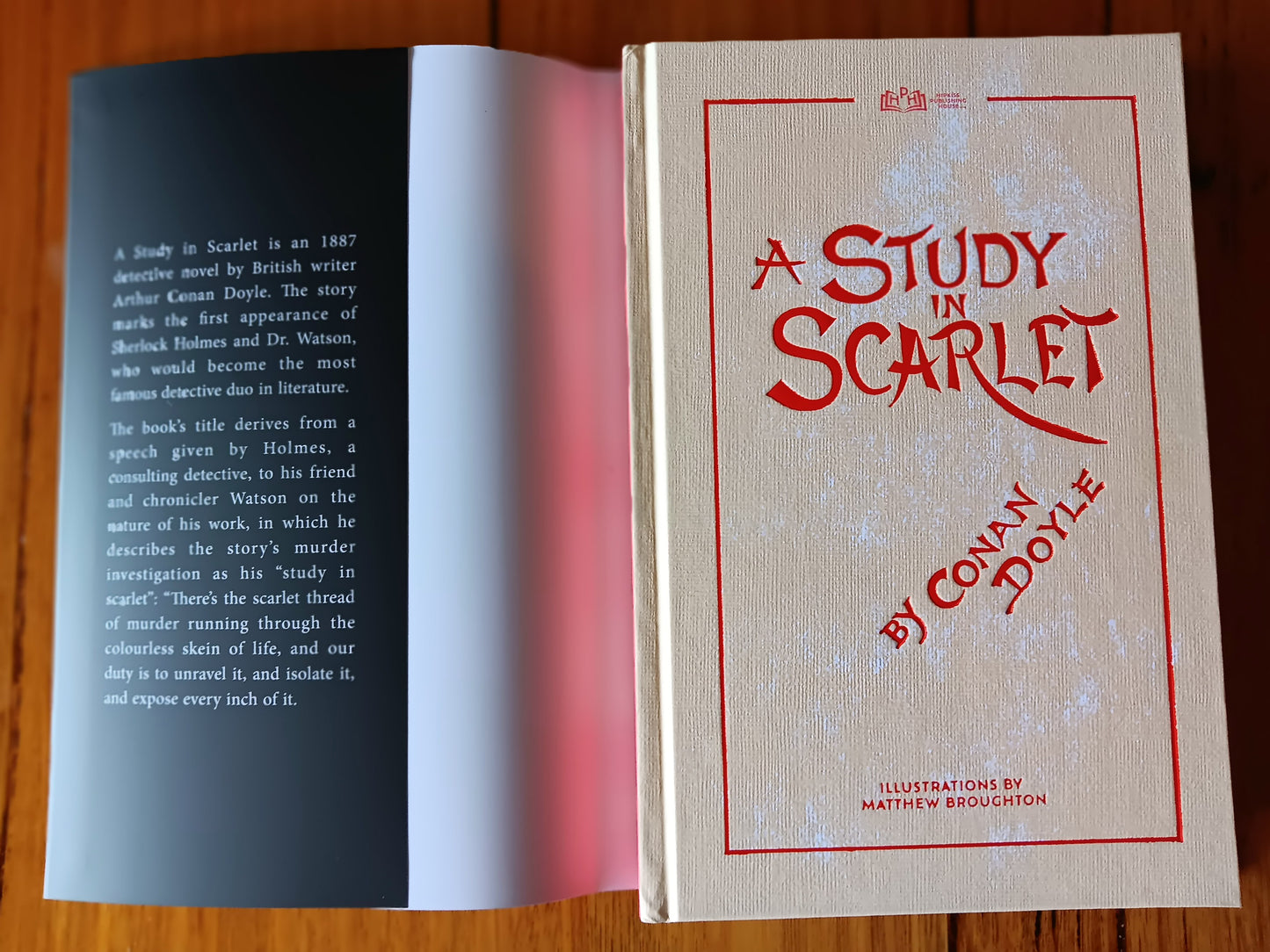 Classic book A Study in Scarlet dust jacket pulled back to reveal hard cover.